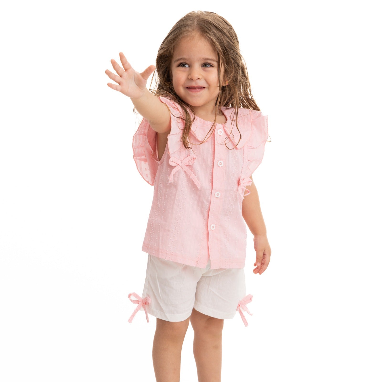 set of pink sleeveless blouse and white shorts with bowtie decoration