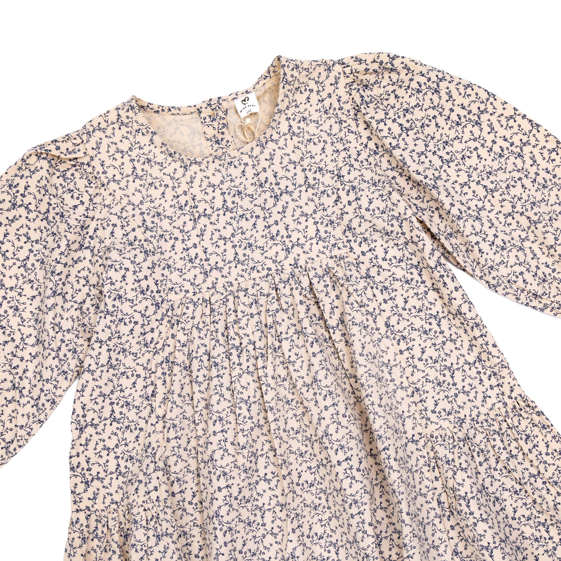Girls' dress in beige with a floral print