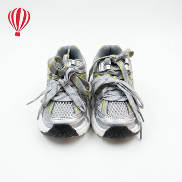 Pair of gray sneakers with yellow accents on a white background