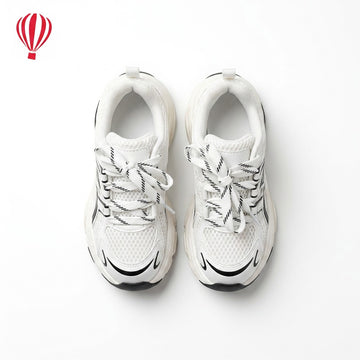 White sneakers with black accents on a white background
