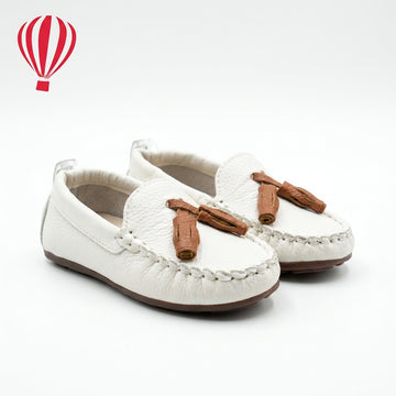 White loafers with brown bows on a white background