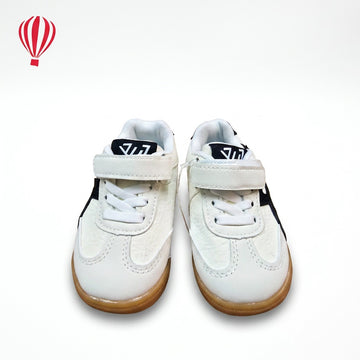 Pair of white sneakers with brown soles on a white background