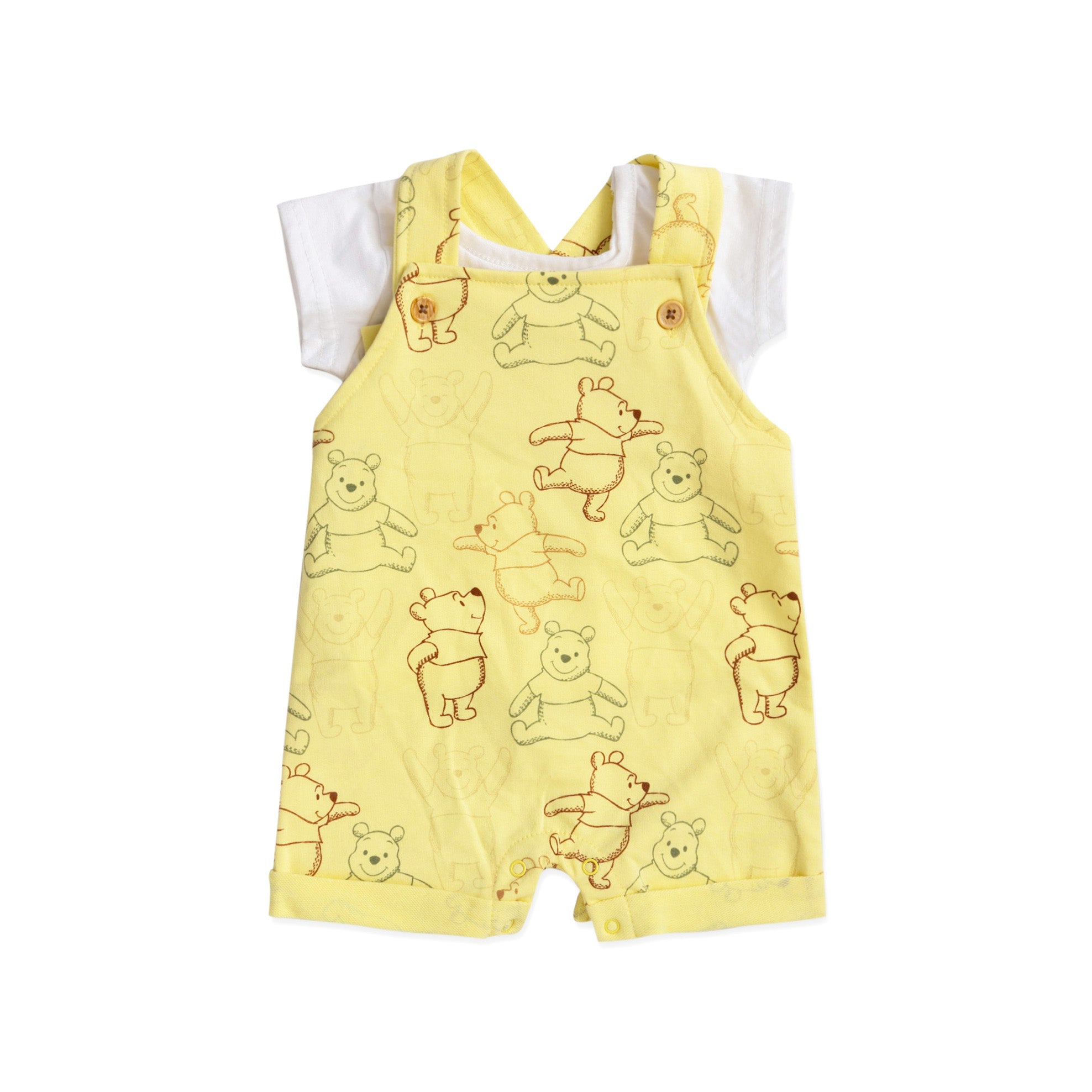 yellow sleeveless salopette with winnie the pooh print and a white top