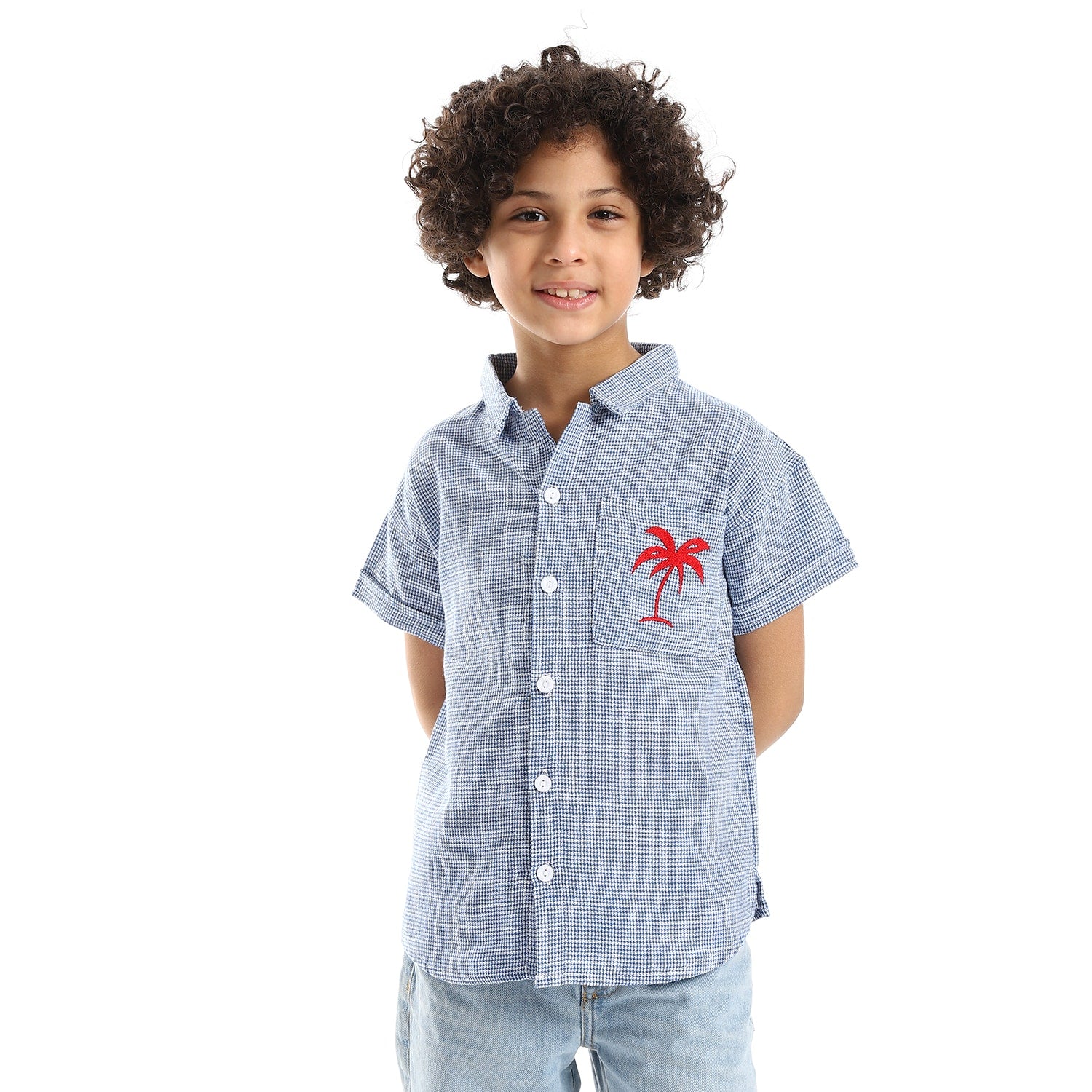 red stitched palm tree over blue white boys shirt